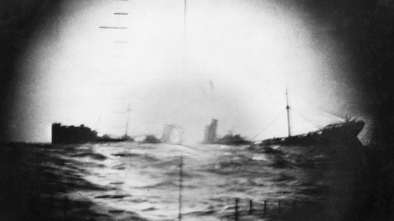 Black and white picture of a Japanese vessel sinking in World War II after being torpedoed by an American submarine.
