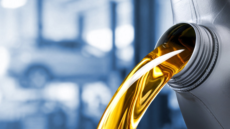 Close-up of motor oil pouring from container.