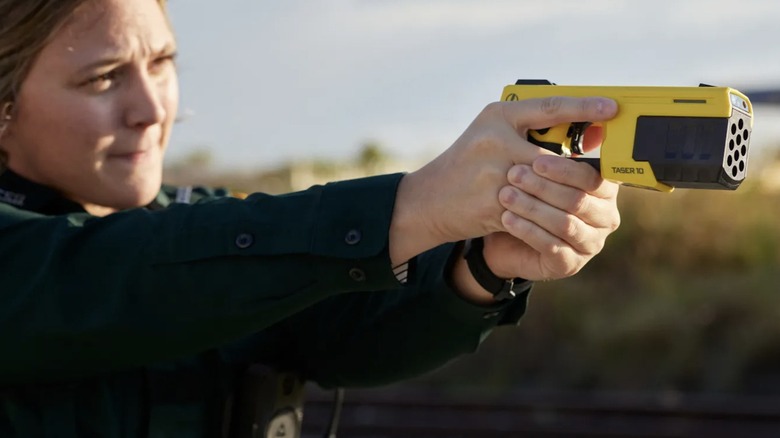 Person aiming a Taser 10
