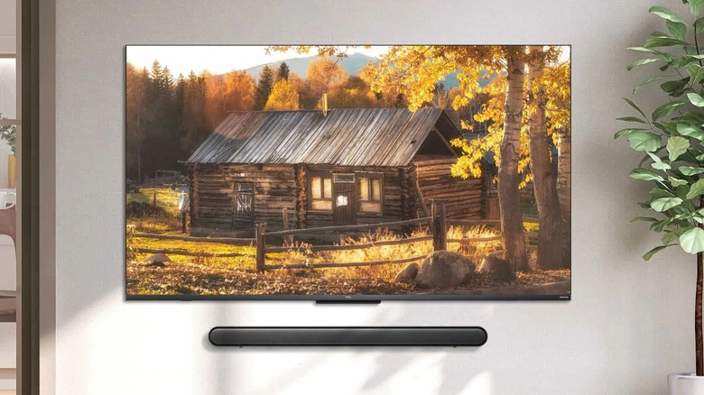 The TCL X955 Premium QD-Mini LED 4K TV, showcased in a promotional image. alongwith a soundbar
