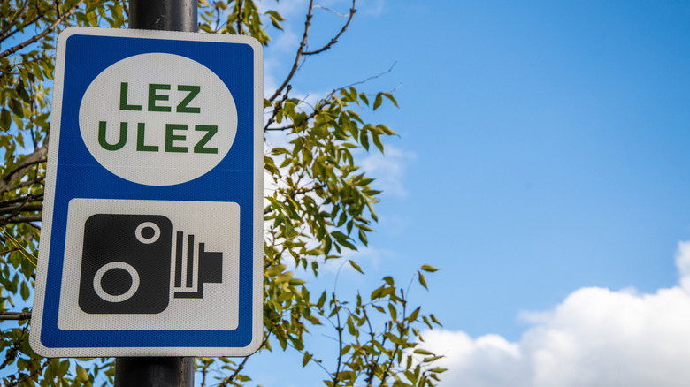 Sign in London showing camera enforcement for ULEZ and LEZ