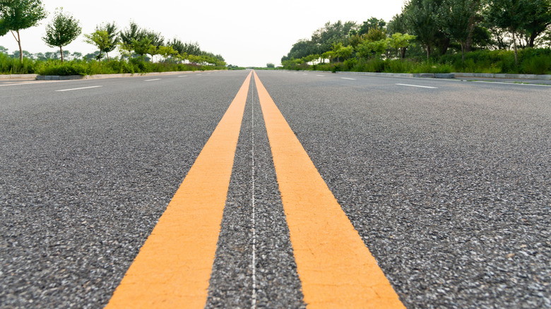 Divided highway marked by double solid yellow lines