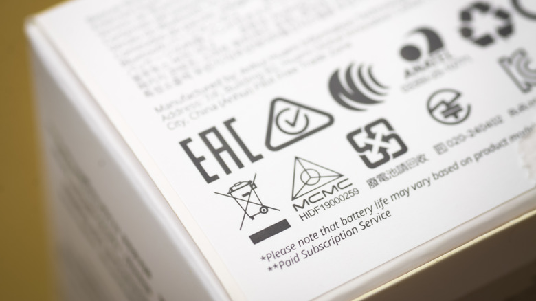 A close up of several different compliance marks, with a focus on the EAC mark