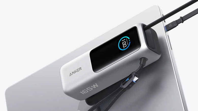 Anker power bank attached to a laptop and charging it.