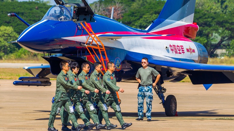 Chengdu J-10 on tarmac with military personnel