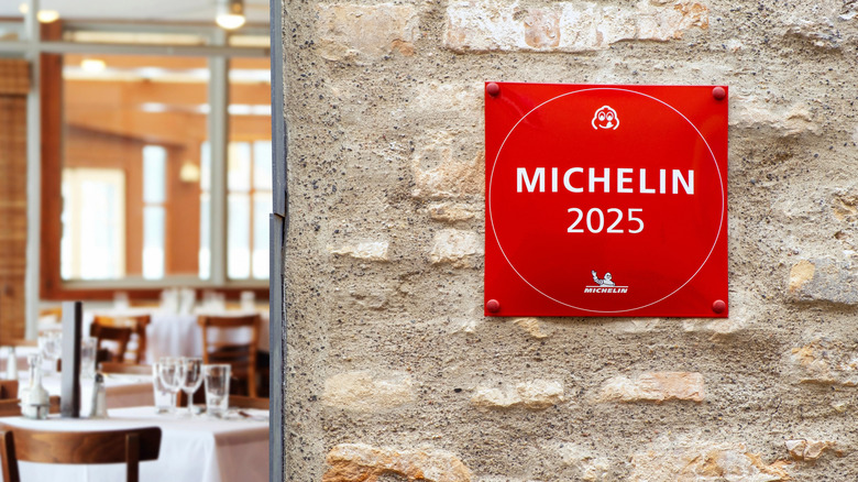 Michelin star for a restaurant hanging on a brick wall