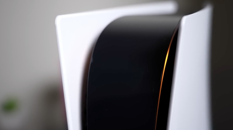 A close-up of the PS5 with the orange LED light