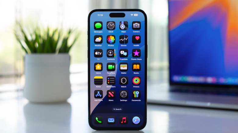 iPhone on a desk showing home screen
