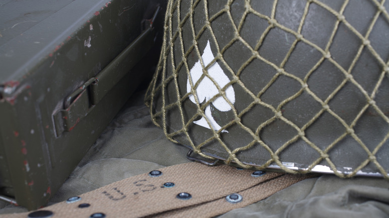 A WW2 U.S. Army helmet with a spade emblem painted on it