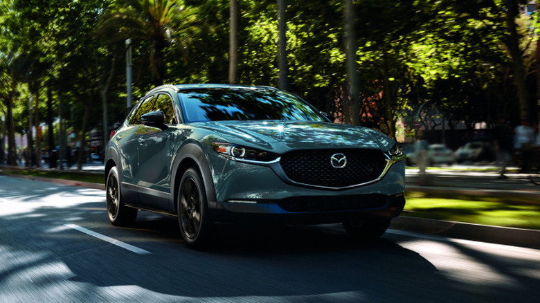 2025 Mazda CX-30 driving on a leafy road