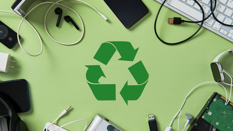 Picture showing electronics surrounding a recycling symbol