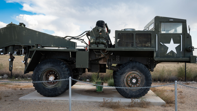 An armored military vehicle on display outside.