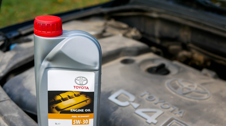 Bottle of motor oil with engine