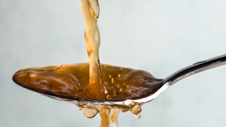 Pouring Apple Cider Vinegar into spoon
