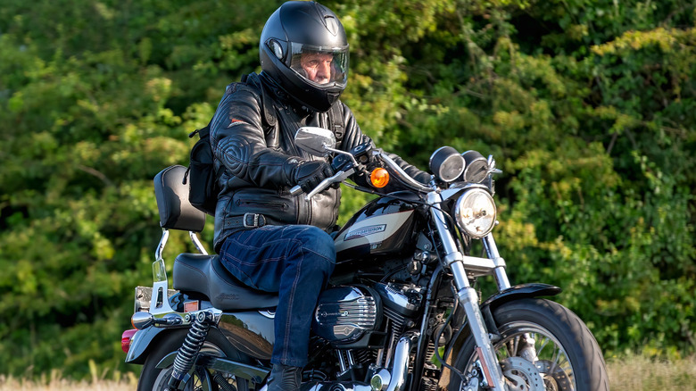 A bike rider riding Harley Davidson XL1200r Sportster motorcycle