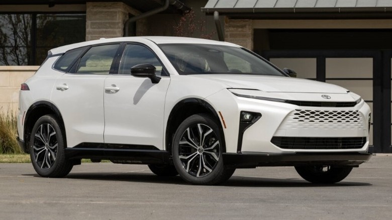 Oxygen White Toyota Crown Signia XLE parked on a paved surface win front of a building