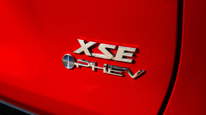 Toyota XSE emblem on a red 2025 Toyota RAV4 Plug-in Hybrid