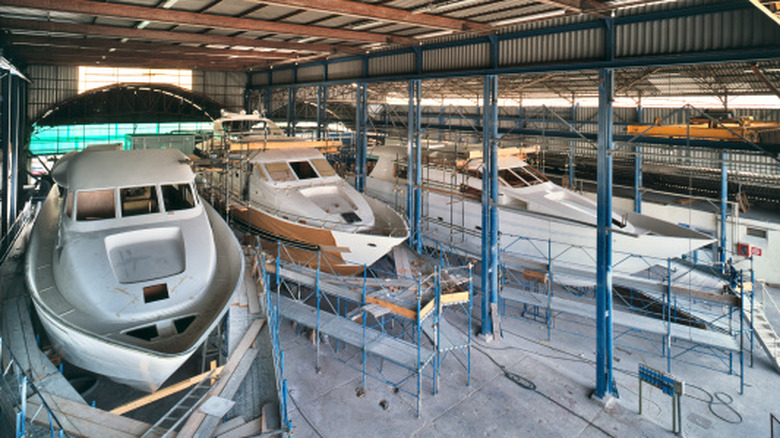 Yachts being assembled in a shipbuilding drydock.