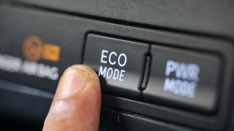 Eco mode switch being pressed.