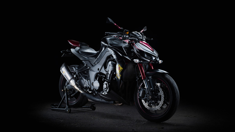 A black and red Kawasaki Z 1000 on display against a black background