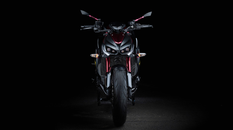 Front view of a black and red Kawasaki Z 1000 on display against a black background