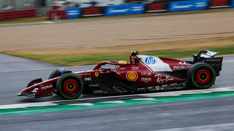 Side view of Lewis Hamilton driving Ferrari SF-25 on track