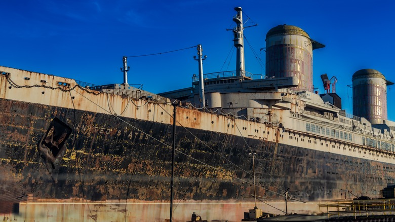 The rusty hull of the SS United States in profile