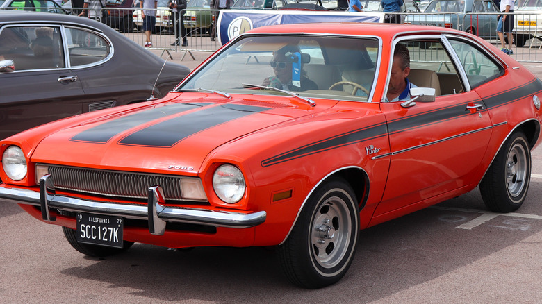 two people inside 1972 Ford Pinto
