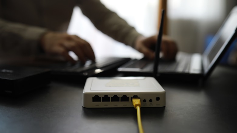 Router on table with laptop and keyboard