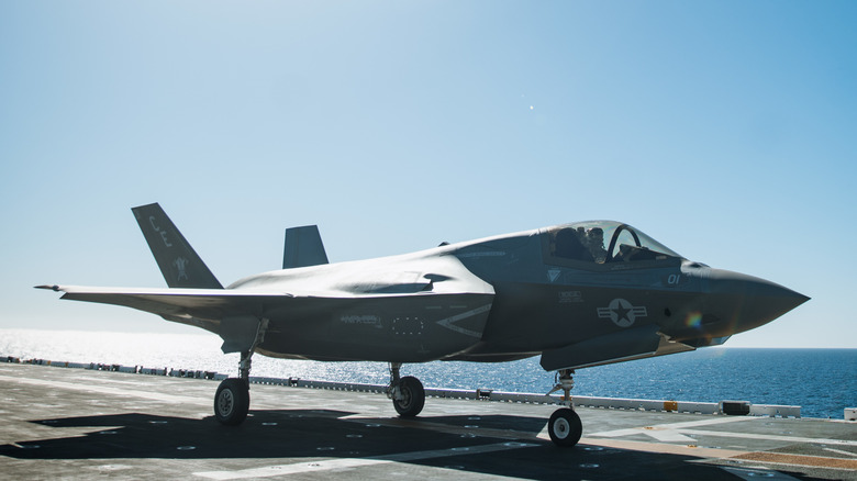 An F-35B sts on a carrier deck at sea