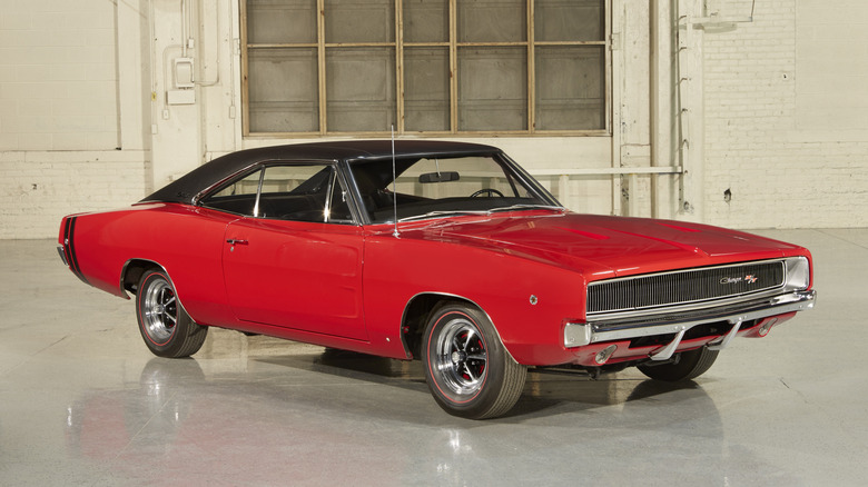 A red 1968 Dodge Charger with a black vinyl roof, front 3/4 view