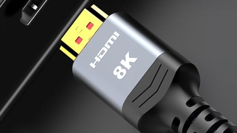 A gold-plated HDMI connector entering a device.