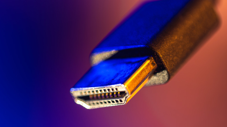 The connector of an HDMI cable under blue lights.