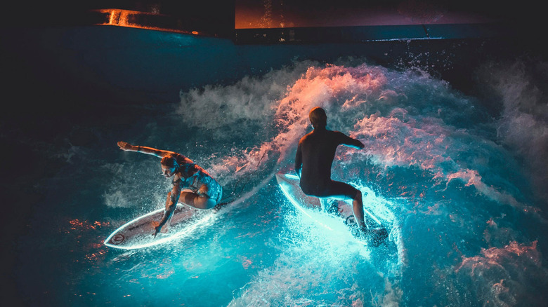 Two people surfing using ActionGlow lights