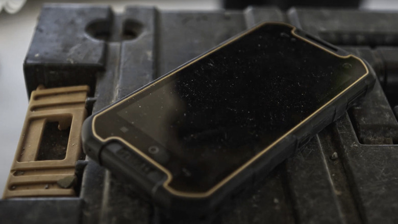 DeWalt's rugged smartphone placed on top of a black toolbox.