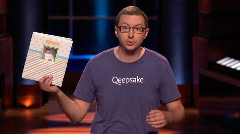 Jeff holding up baby memory book