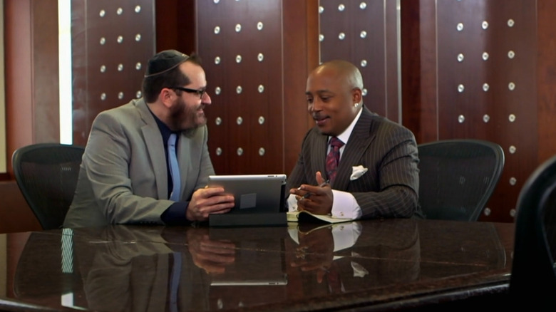Moshe and Daymond sitting in office using an iPad