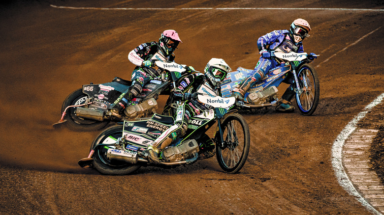 Speedway bikes swerving around a corner