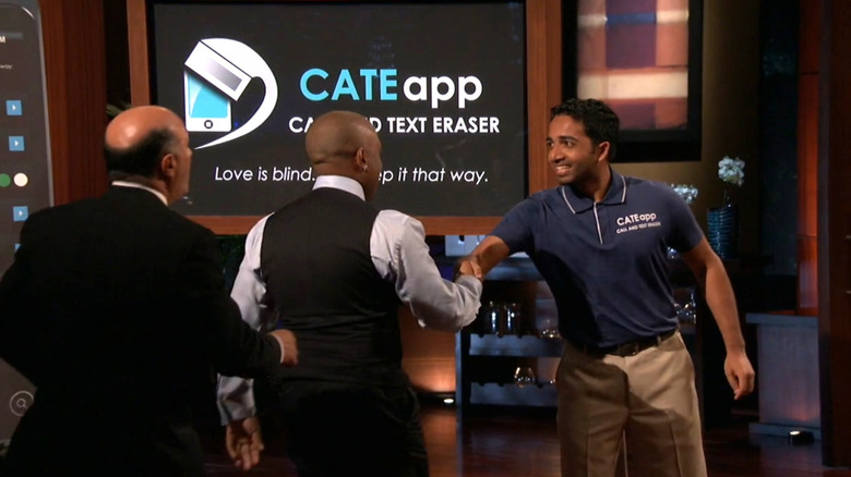 Kevin O'Leary and Daymond John shake hands with Neal Desai on Shark Tank Season 4