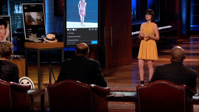 Amy presenting next to FashionTap display before the sharks