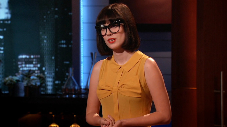 Amy looking at the sharks and speaking while on Shark Tank