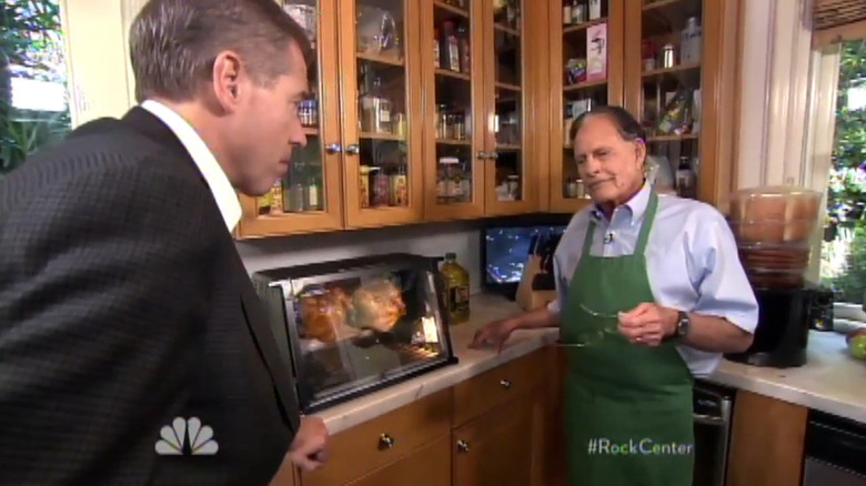 Brian Williams interviewing Ron Popeil in 2013 in front of a working Showtime Rotisserie