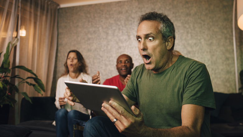 Fans react to a sporting event streamed on a tablet