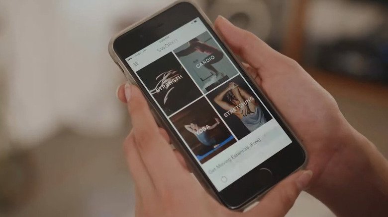 Person looking through Sworkit app exercises