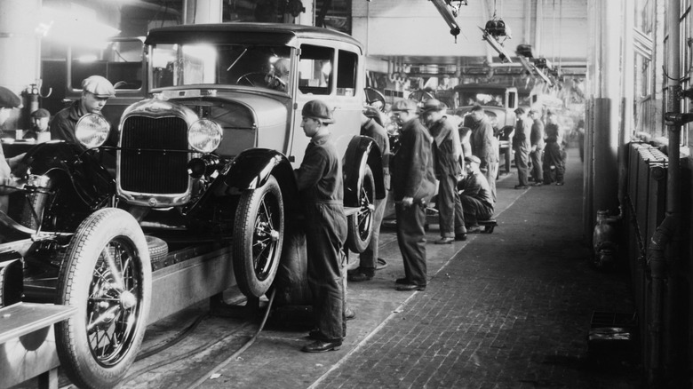 Assembly line workers inside the Ford Motor Company factory at Dearborn, Michigan.