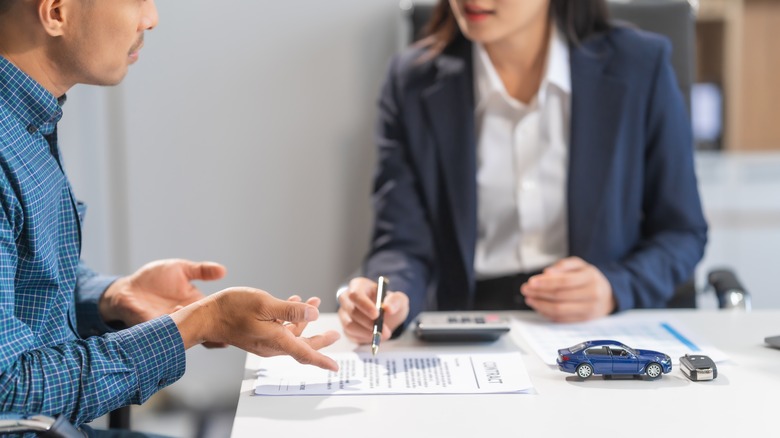 Stock photo of car sales discussions