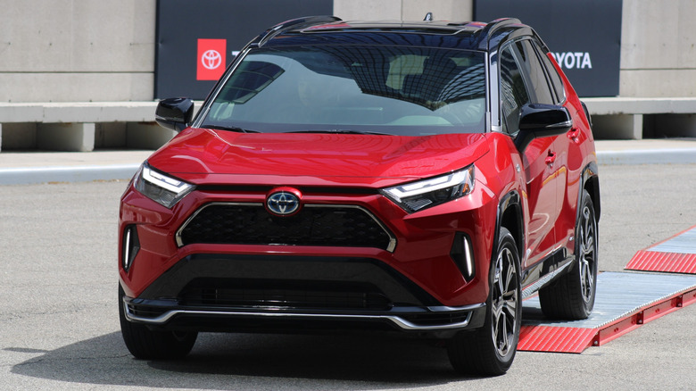 Red 2023 Toyota RAV4 Prime parked on ramps