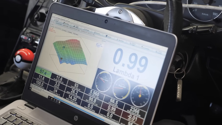 A laptop connected to a car's ECU helps tune it