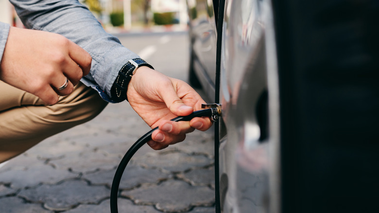 man putting air in tire