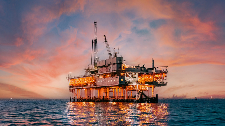 An offshore oil rig set against a beautiful sunset off the coast of Huntington Beach, California